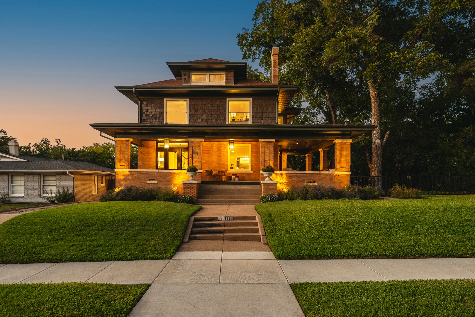 Historic Fort Worth home at twilight with warm glowing windows